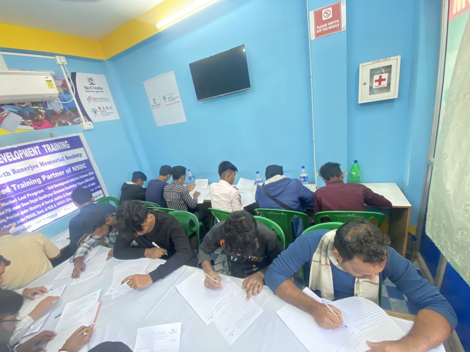 Students at a long table taking a test